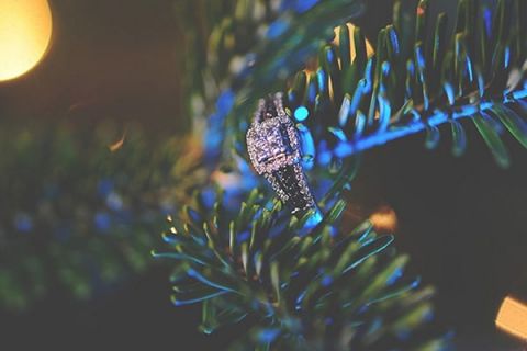 Square Cut Engagement Ring hung in a Christmas Tree | Ashlee Mintz Photography | See More:https://heyweddinglady.com/a-green-and-white-holiday-wedding-at-a-train-station-from-ashley-mintz-photography/