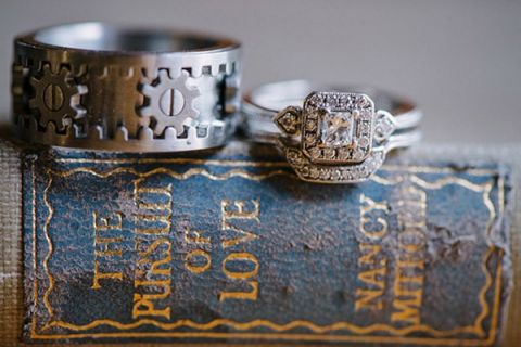 A Steampunk Gear Groom's Ring and Vintage Engagement Ring | Milton Photography | See More: https://heyweddinglady.com/ruby-and-gray-wedding-with-vintage-book-details-from-milton-photography/