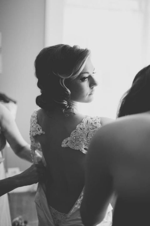 Romantic Lace Back Wedding Dress for a Classic Bride | Black and Hue Photography | See more: https://heyweddinglady.com/cherry-red-black-and-ivory-rustic-chic-wedding-from-black-and-hue-photography/