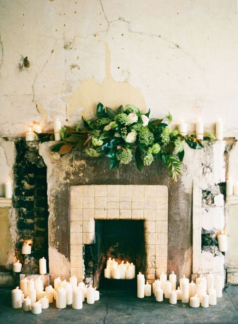 Marble Mantelpiece Draped in Candles and Greenery for a Romantic Wedding Ceremony | Katie Stoops Photography | See More! https://heyweddinglady.com/cashmere-and-champagne-warm-neutral-wedding-inspiration/