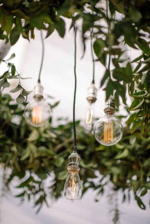 Greenery and Edison Bulb Chandelier | Sean Money + Elizabeth Fay Photography | See More! https://heyweddinglady.com/farm-table-luxe-organic-wedding-inspiration/