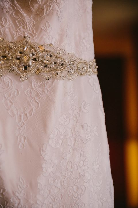 Romantic Lace Wedding Dress with a Crystal Sash for a Sweetly Opulent Black Tie Texas Wedding | PhotoHouse Films | See More! https://heyweddinglady.com/sweetly-opulent-black-tie-texas-wedding/