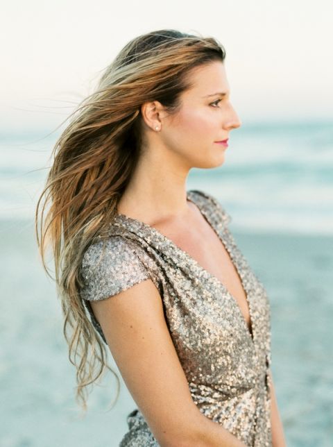 Champagne Sequin Romper and Natural Beachy Hair | JoPhoto | Marsala and Champagne Engagement on the Beach - https://heyweddinglady.com/marsala-and-champagne-engagement-on-the-beach/