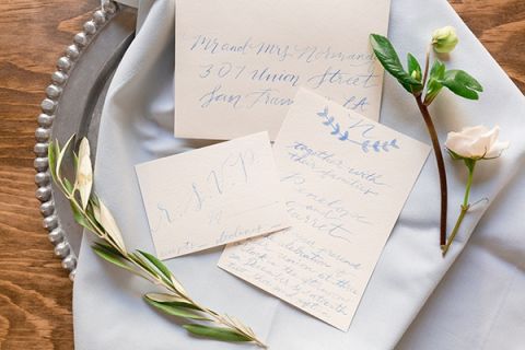 Chic Gray and Blue Calligraphy Invitation | Gavin Farrington Photography | Event Design and Styling by Glow Event Design - https://heyweddinglady.com/winter-chic-intimate-holiday-wedding-cozy-neutrals-2