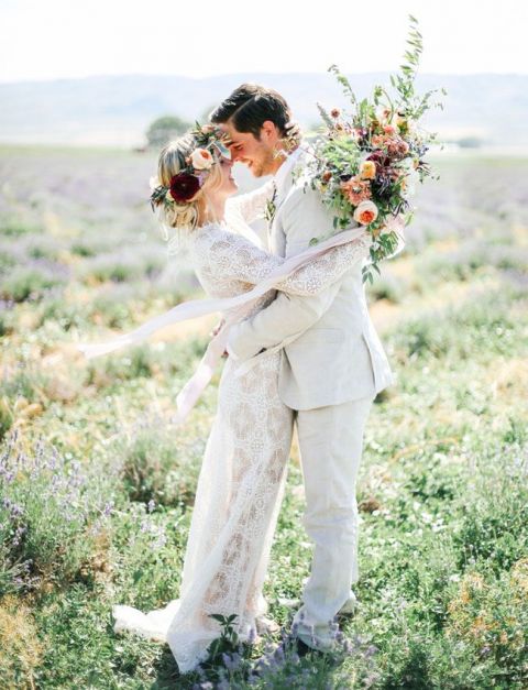 Whimsical Bohemian Bride and Groom with a Lace Wedding Dress in a Lavender Field | Tessa Barton Photography | https://heyweddinglady.com/wild-heart-carefree-bohemian-wedding-peach-sage/