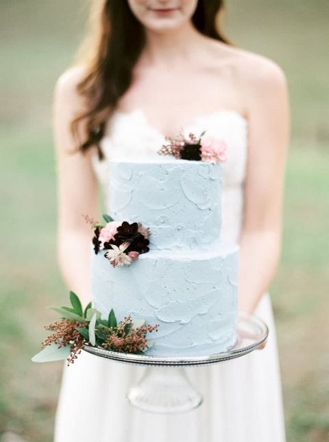 Bride Holding a Blush and Blue Cake