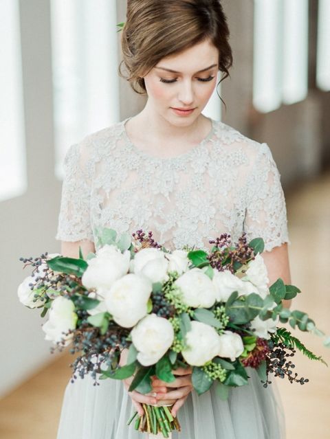 Gray Lace Wedding Dress with a Green and White Bouquet