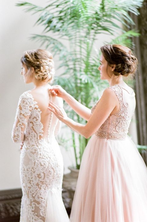 Helping the Bride into her Nude Illusion Lace Wedding Dress