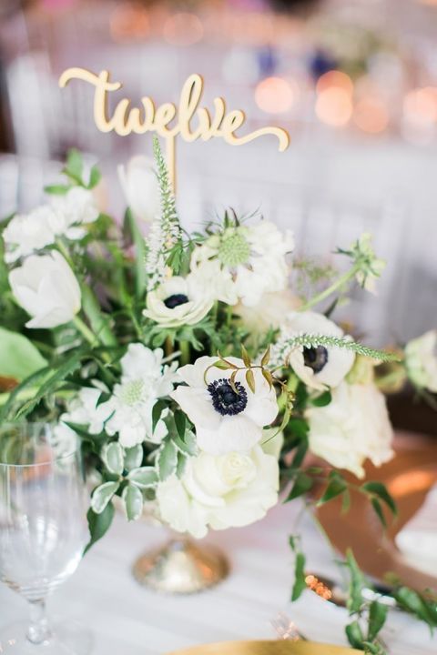 Gold Calligraphy Table Numbers in a Greenery Centerpiece