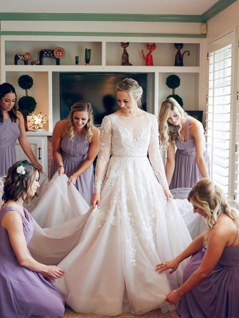 Bridesmaids in Lilac Dresses Helping the Bride Get Ready