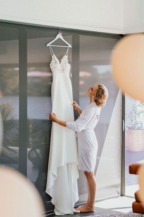 Bride Putting on her Wedding Dress