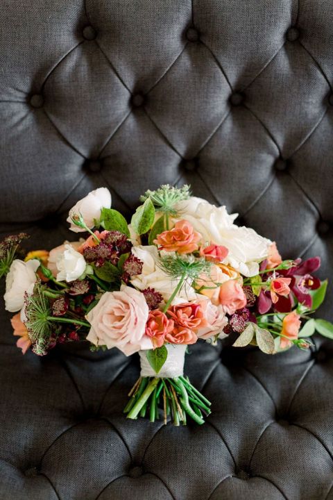 uPeach and Burgundy Bridal Bouquet on a Gray Tufted Chair