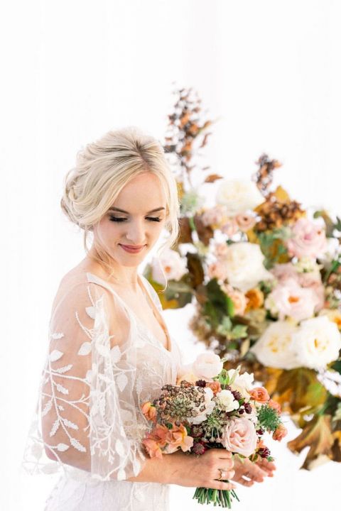 Romantic Half Up Bridal Hairstyle with Fall Leaf Wedding Ceremony Decor