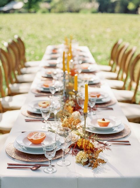 Fall Celebration Tablescape with Orange and Yellow Decor and a Dried Flower Runner