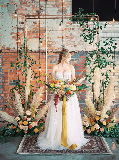 Pampas Grass and Exposed Brick Ceremony Decor for a Colorful Boho Fall Warehouse Wedding