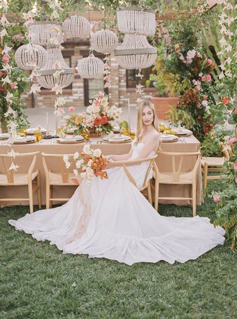 Coral Bali Wedding Style with a Bohemian Arbor and Hanging Wood Bead Lanterns