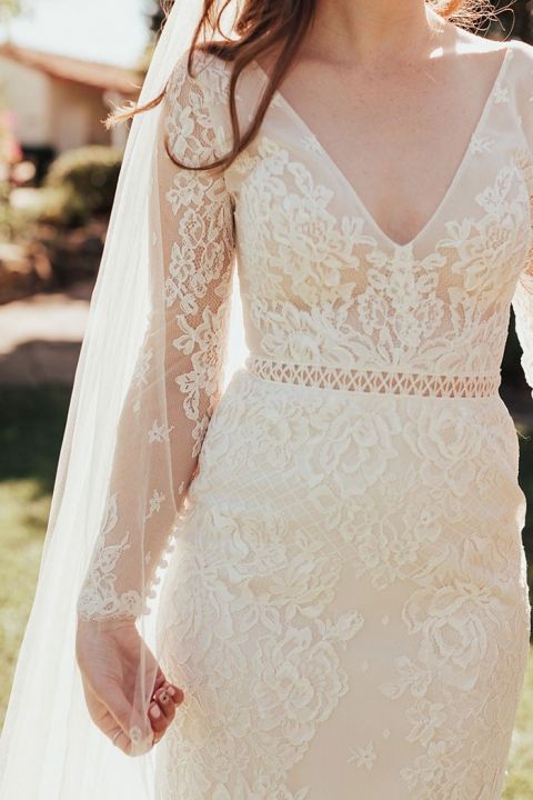 Vintage Bridal Style with a Long Lace Veil and Sleeved Wedding Dress