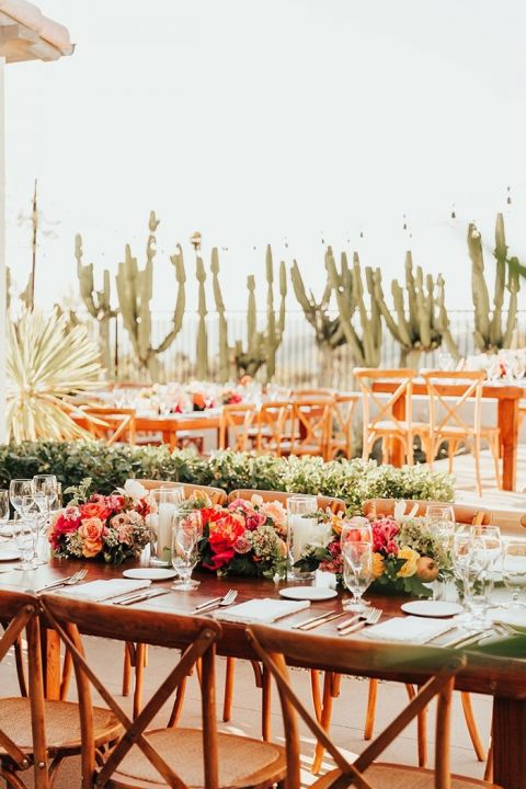 Rustic Wood Tables and Chairs with Vibrant Fall Flowers for a Hacienda Backyard Wedding Reception