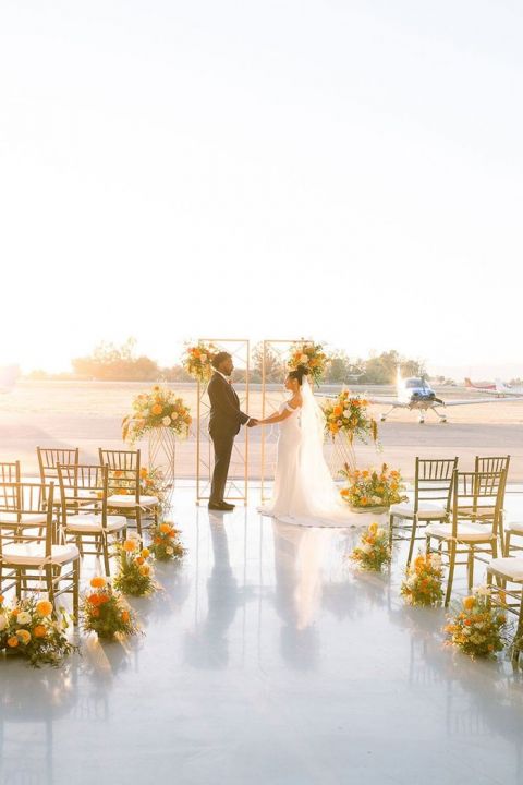 Adventure Wedding Ceremony Backdrop at a Private Air Field for a Unique Wedding Venue