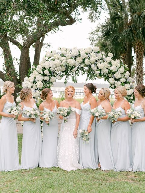 Waterfront Wedding Ceremony Arch with Airy White and Coastal Blue Flowers and Bridesmaid Dresses