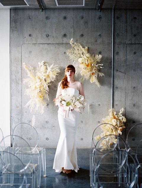 Industrial Wedding Ceremony with Airy Dried Flower Installations and Pantone Colors of the Year Ultimate Gray and Illuminating for a Soft Glow