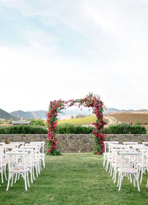 Beautiful Wedding Ceremony with Views of Napa Valley and a Colorful Pink Flower Arch