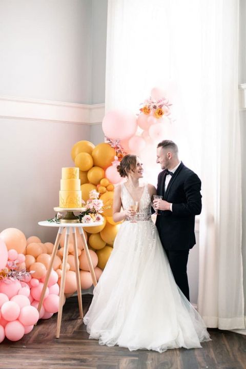 Colorful Balloon Decor adds Pink and Yellow to a Historic Wedding Venue