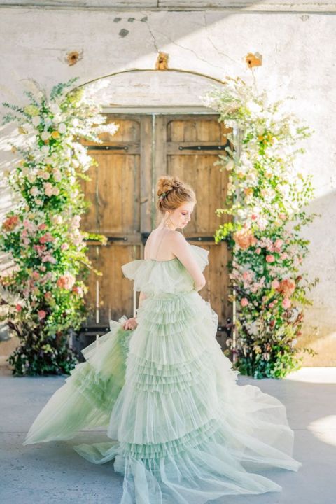 Green Ruffled Wedding Dress with a Floral Framed Door Ceremony